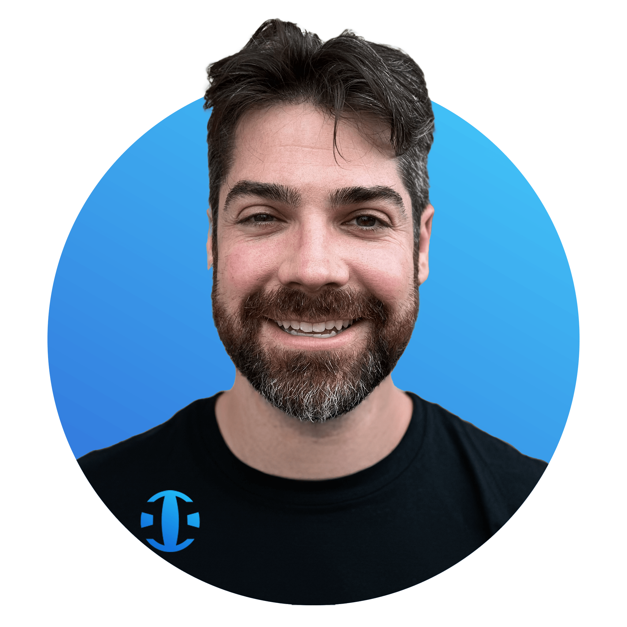 Headshot of a smiling man with dark hair, beard, and mustache, wearing a black t-shirt with a blue logo, against a blue gradient background.