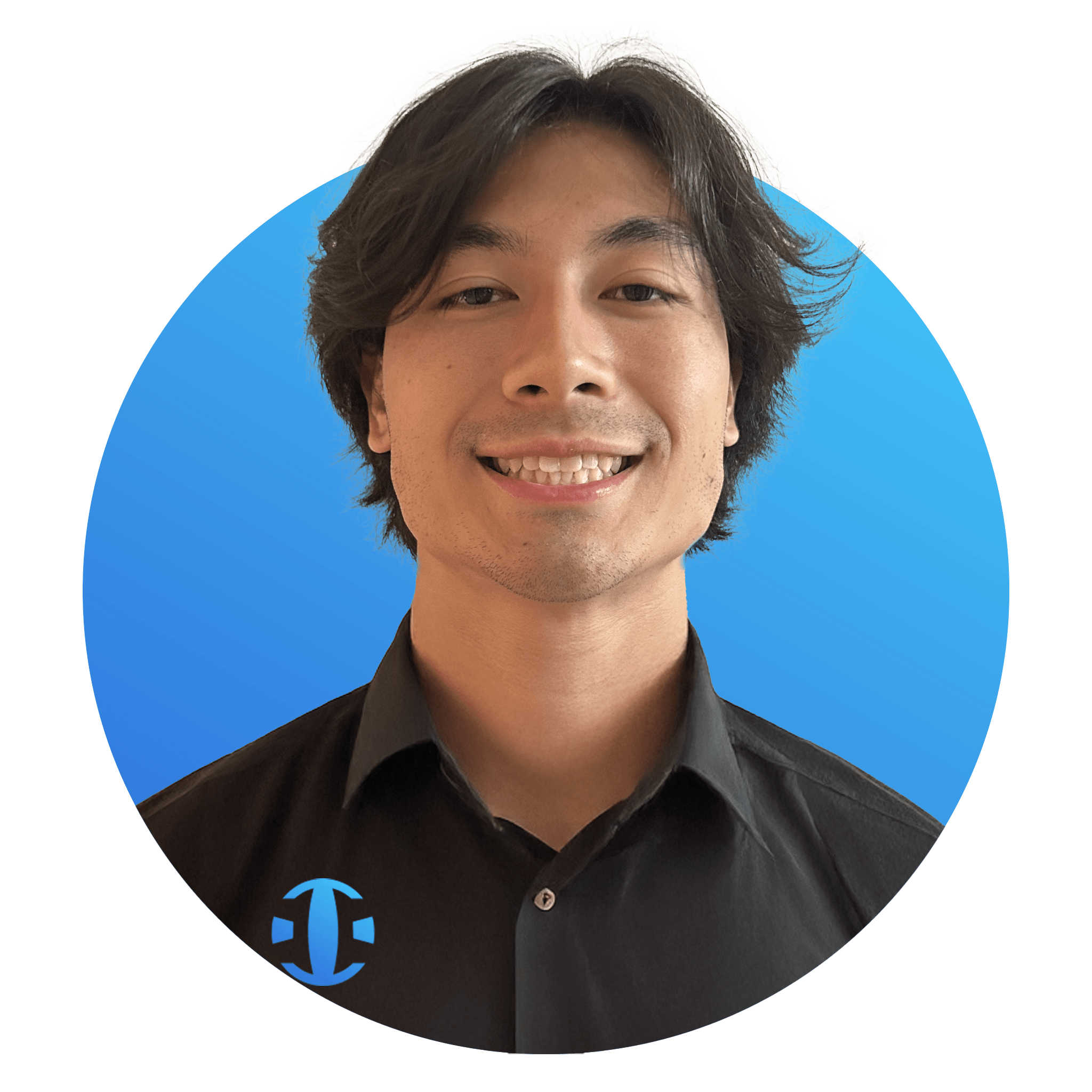 A smiling man with dark hair, wearing a black shirt, against a blue background with a logo in the bottom left corner.