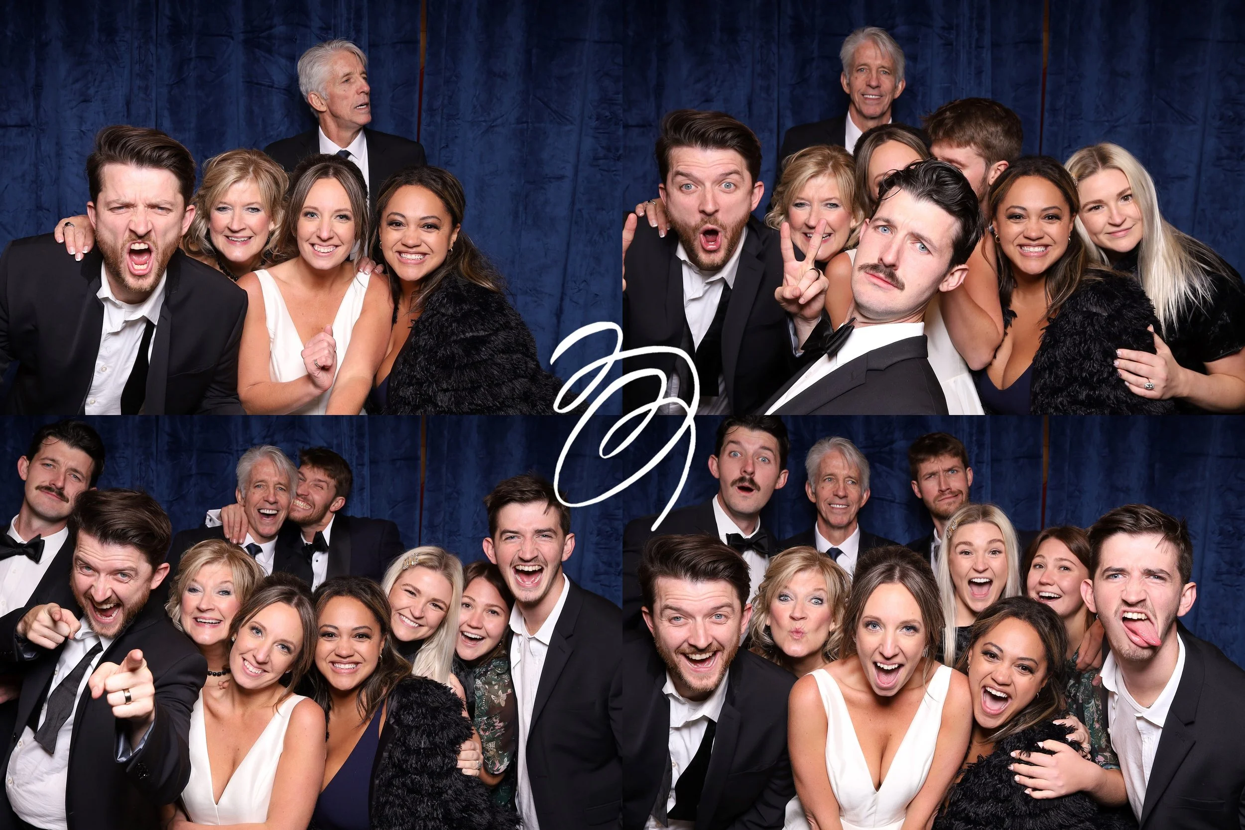 Group of people at a photo booth during a celebration, dressed in formal attire, with some making funny faces and poses, set against a blue curtain background.