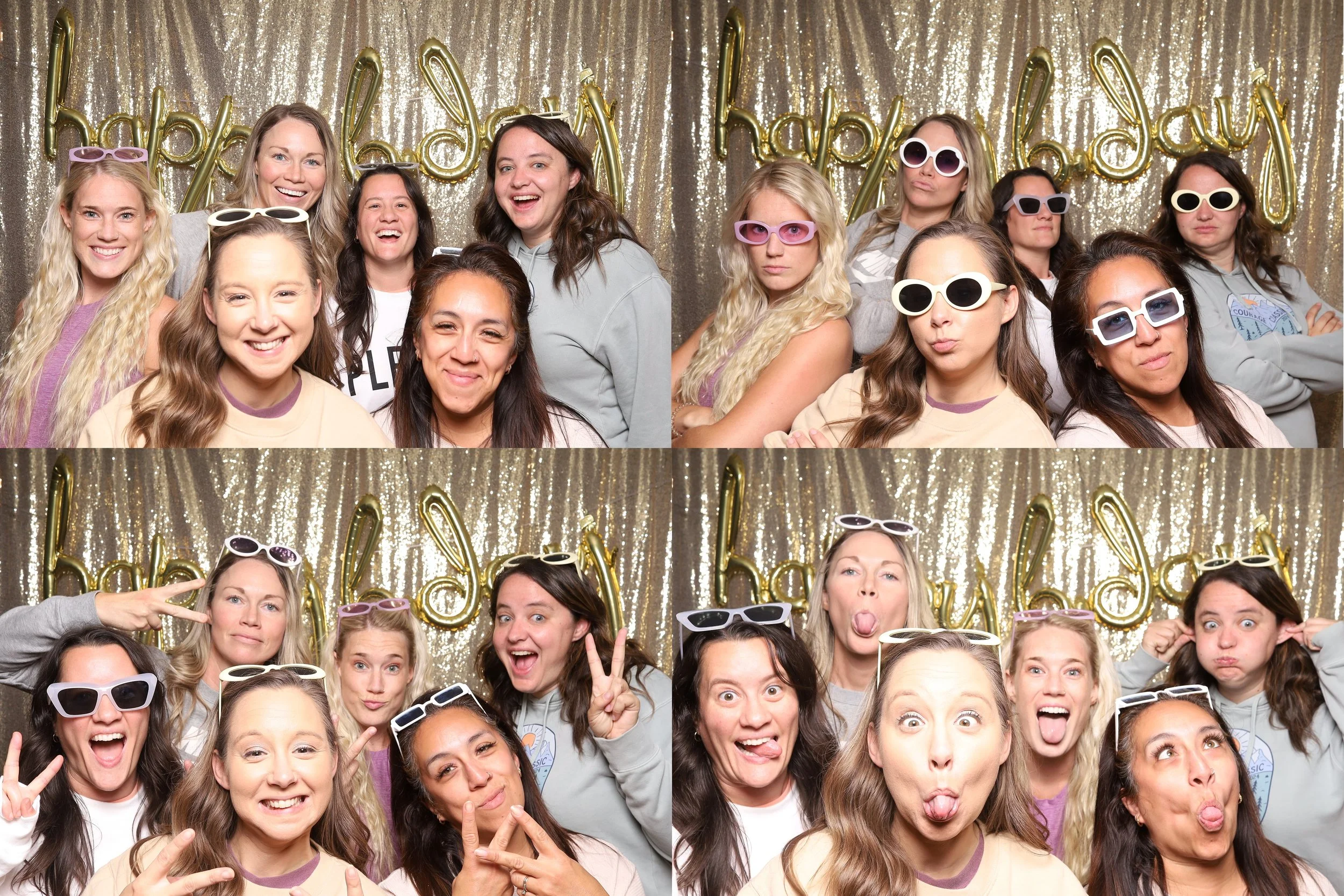 A group of women celebrating a birthday, taking a photo booth picture in front of a golden glittery backdrop with 'happy birthday' balloons, wearing sunglasses, making funny faces, and posing in various ways.