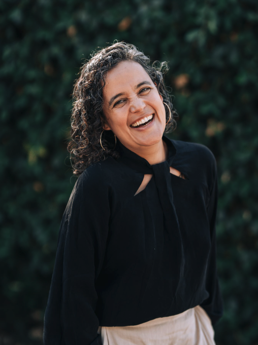 Emma Teresa Pineda Fortin, bilingual somatic and embodied leadership coach at The Bench, in a professional headshot