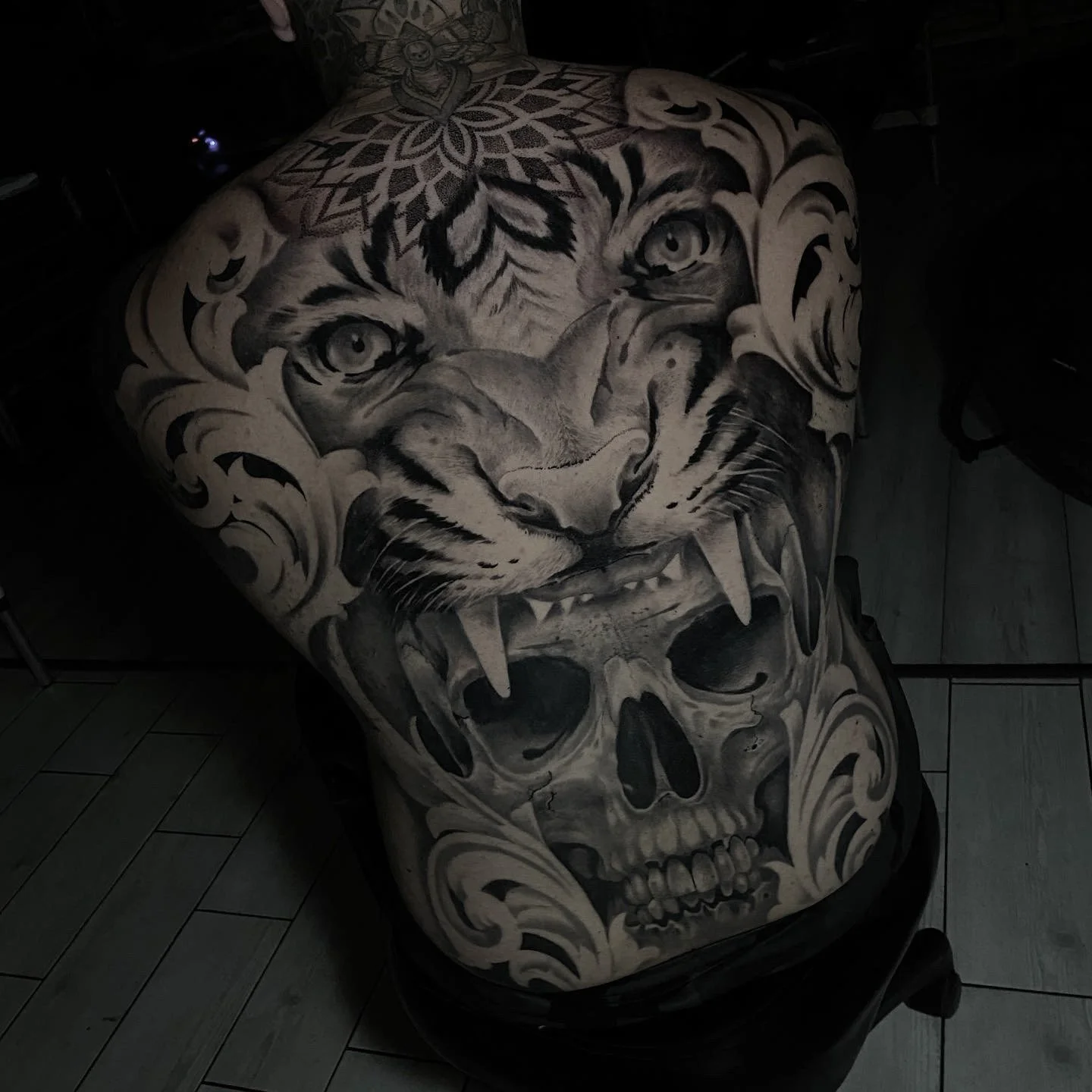 Tattooed motorcycle seat cover featuring a realistic tiger face combined with a skull design.