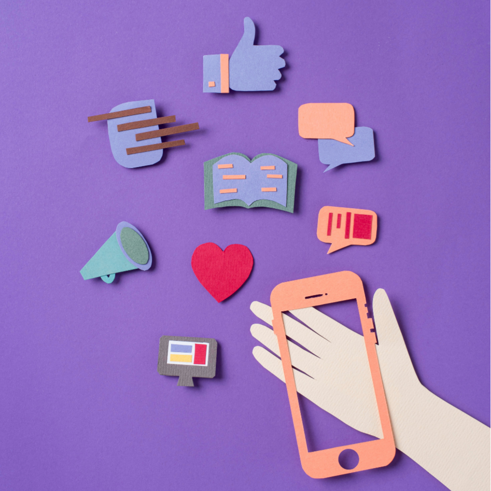 Felt craft icons on purple background including a thumbs-up, speech bubbles, book, megaphone, heart, computer monitor, and a hand holding a smartphone.