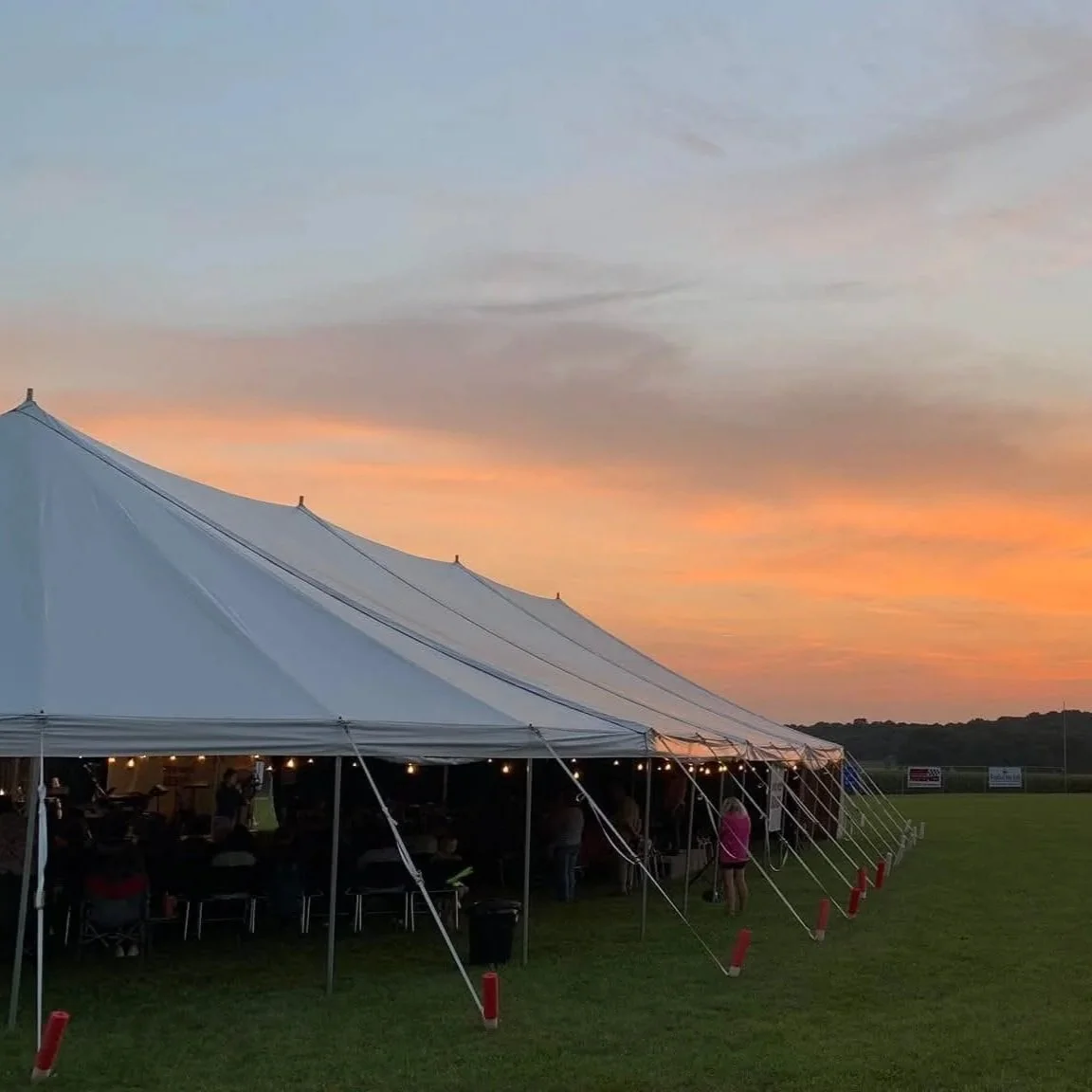 Large white event tent set up outdoors.