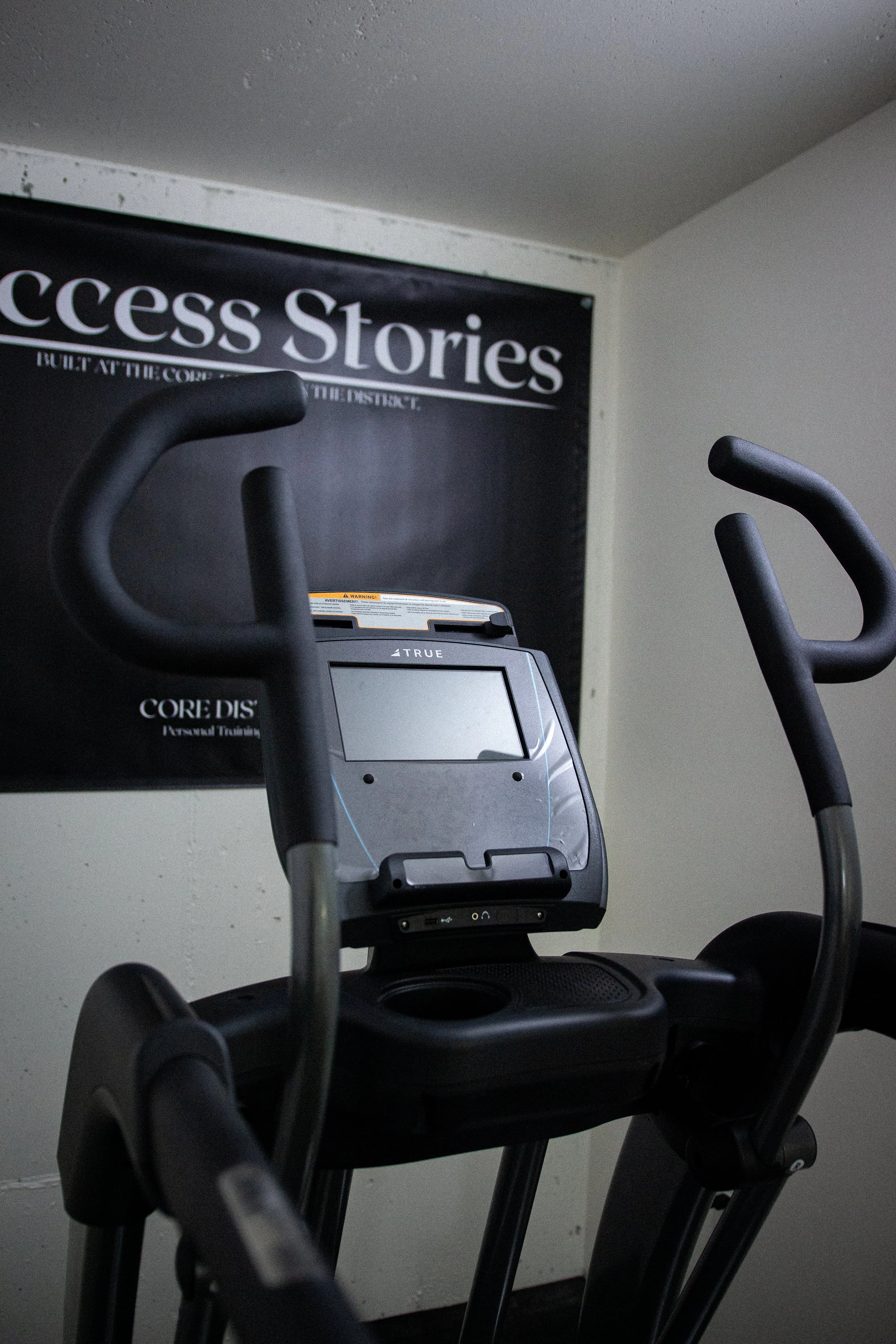 Exercise elliptical machine with digital display in a fitness room.
