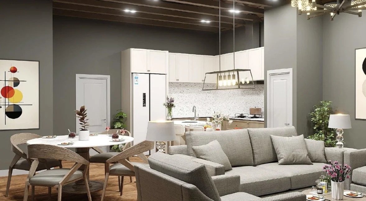 Open-concept living room and kitchen with gray walls, white cabinets, gray sofa, dining table, modern art, and decorative plants.