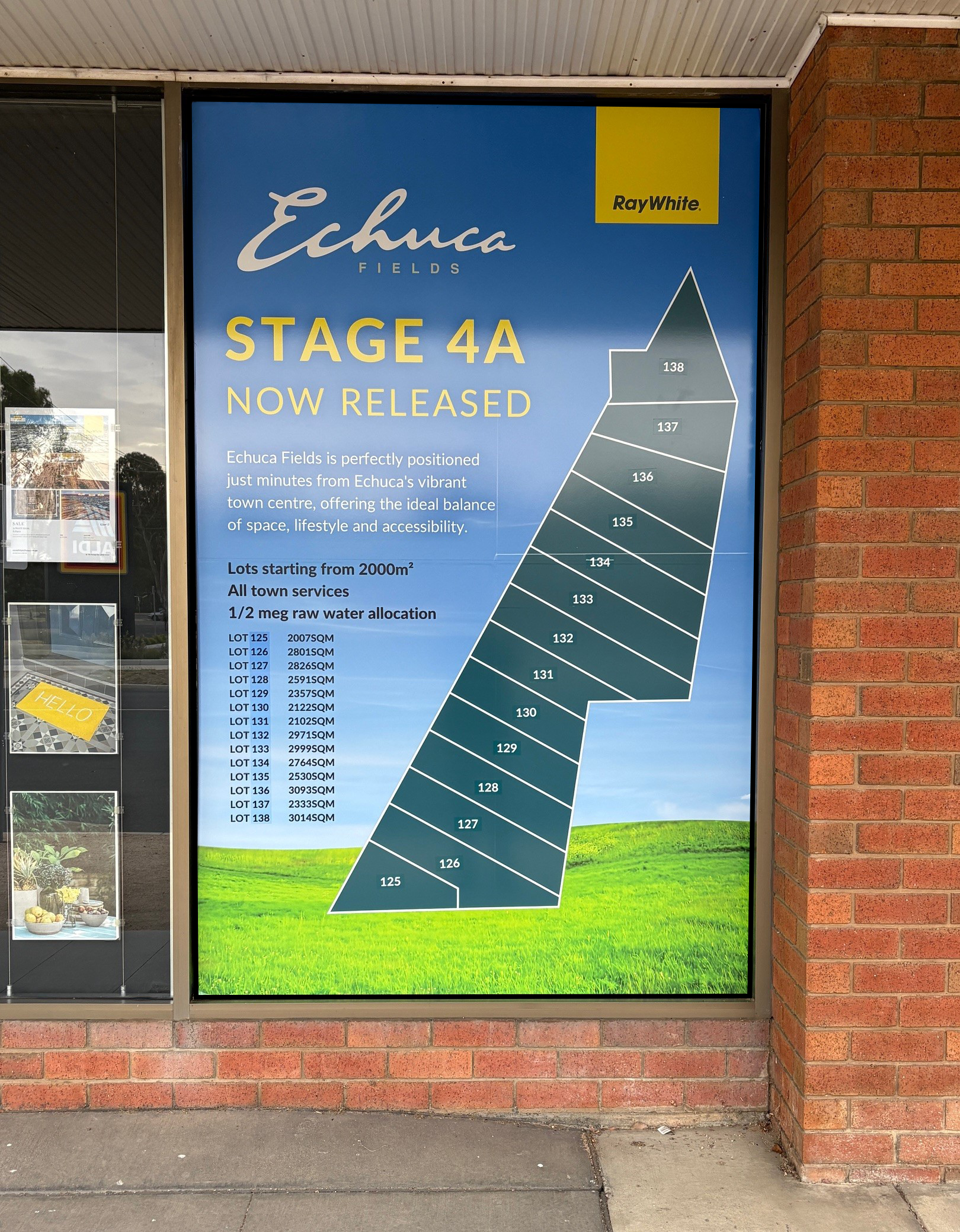A large advertisement poster for Echuca Fields, a real estate development, featuring a map of lots for sale from 125 to 138. The poster highlights that Stage 4A is now released, with lots starting from 2000 square meters, located near Echuca's town center, with all town services and water allocation. The company RayWhite is also displayed on the poster.