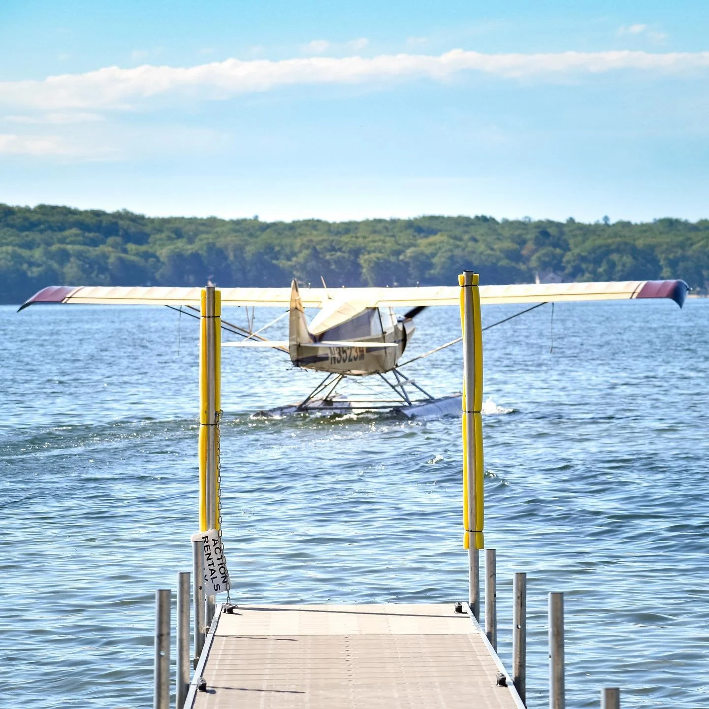 Piper seaplane departing a dock on a Michigan lake