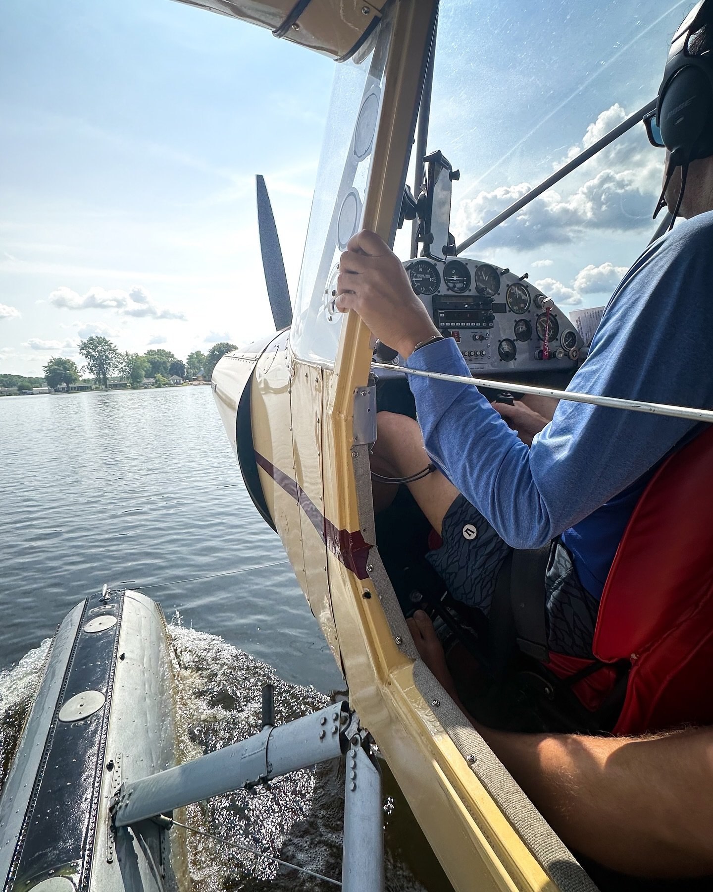 Seaplane training flight with pilot practicing water operations in Michigan