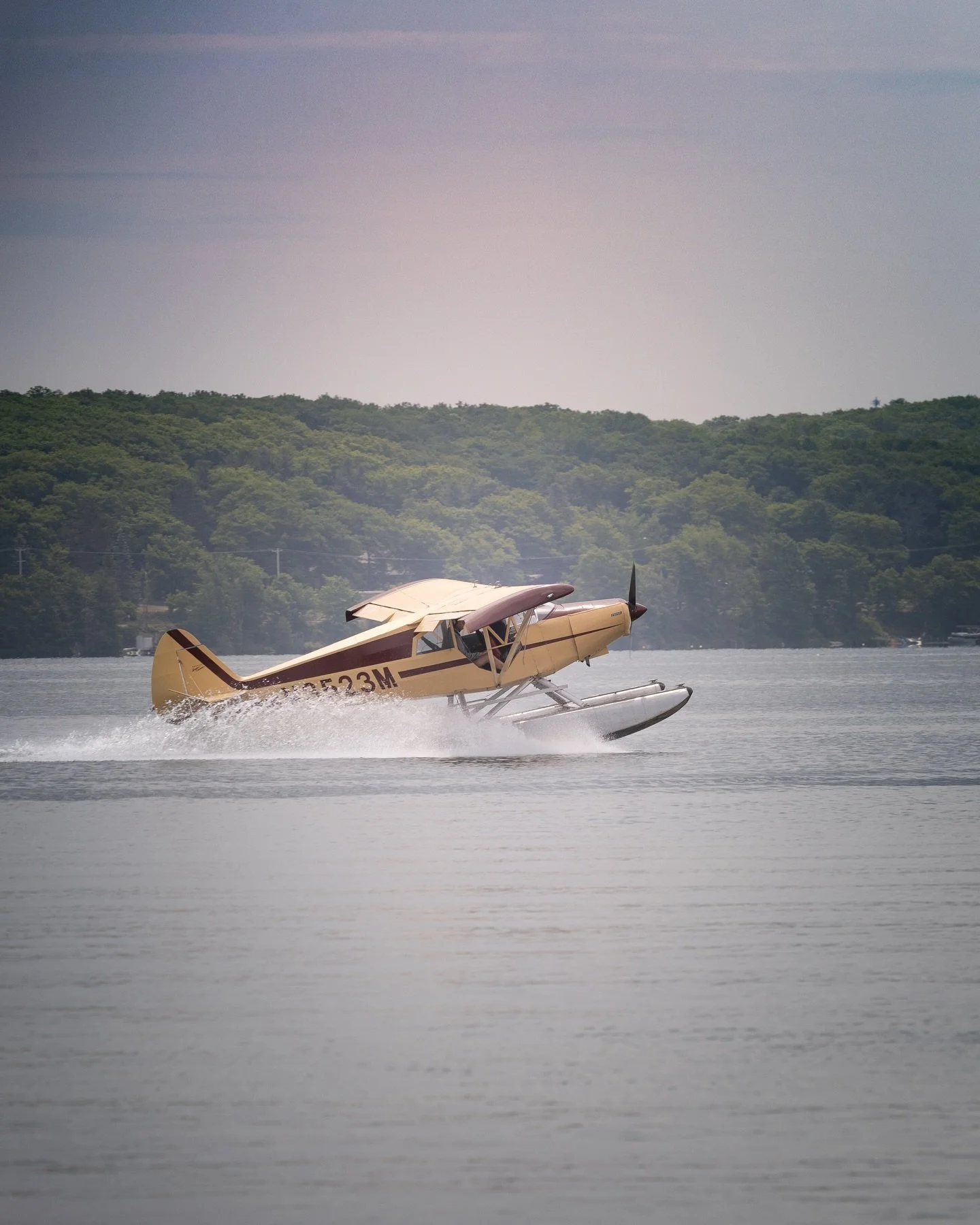 Piper seaplane accelerating on the water during takeoff on a Michigan lake