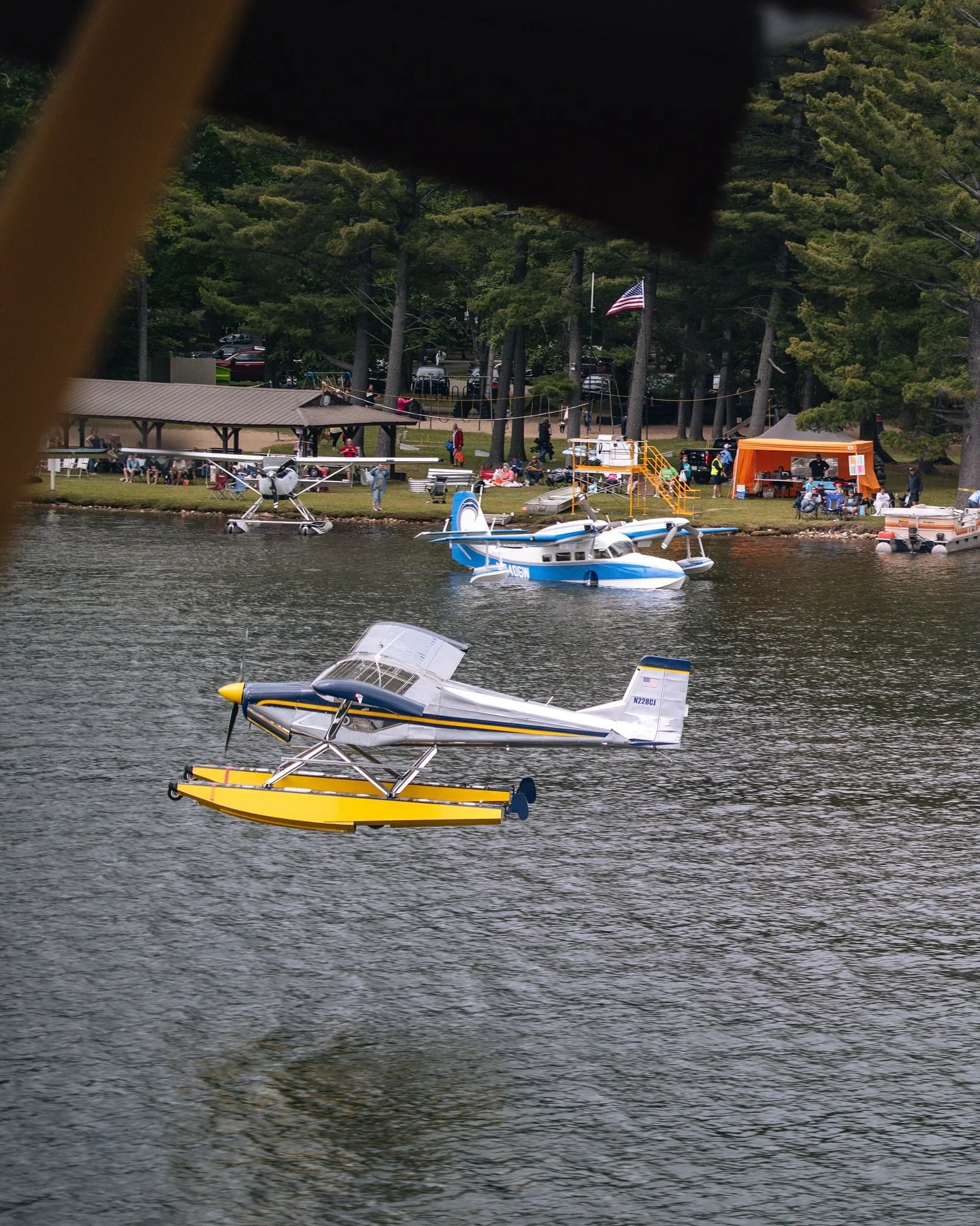Multiple seaplanes operating on a Michigan lake during a seaplane event