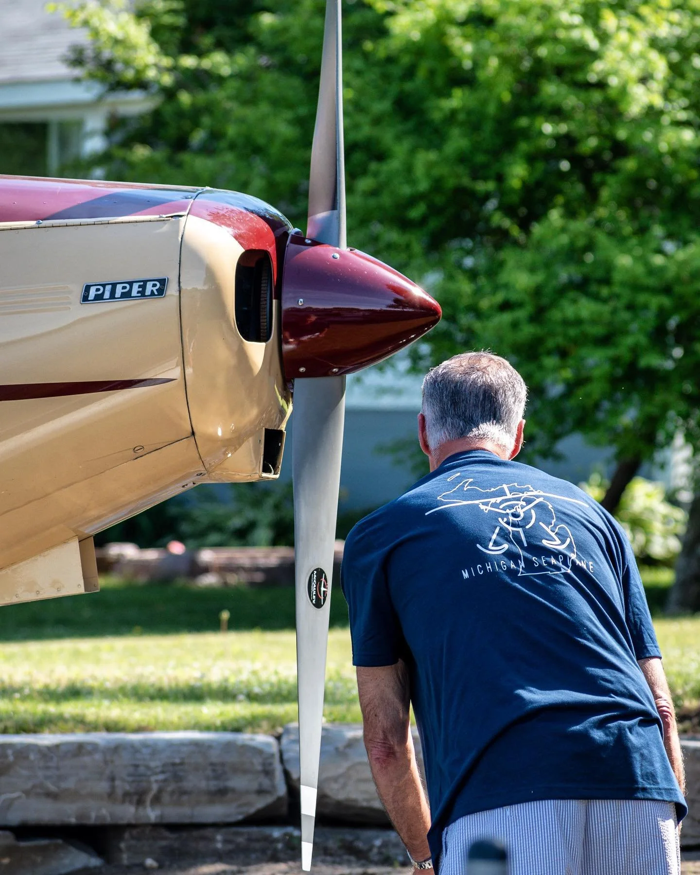 Seaplane pilot conducting a preflight inspection on a Piper aircraft