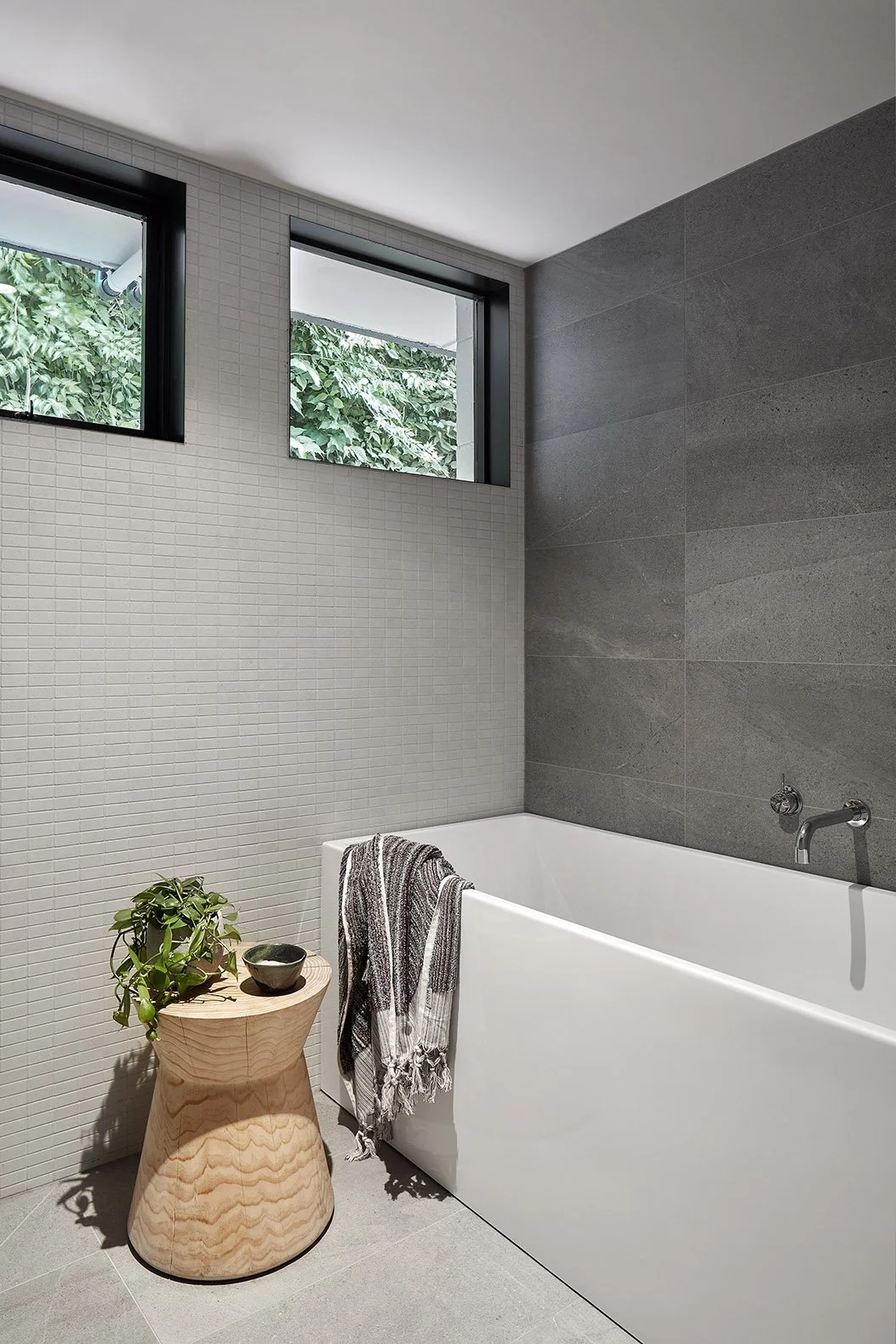 Tiled bathroom with white tub