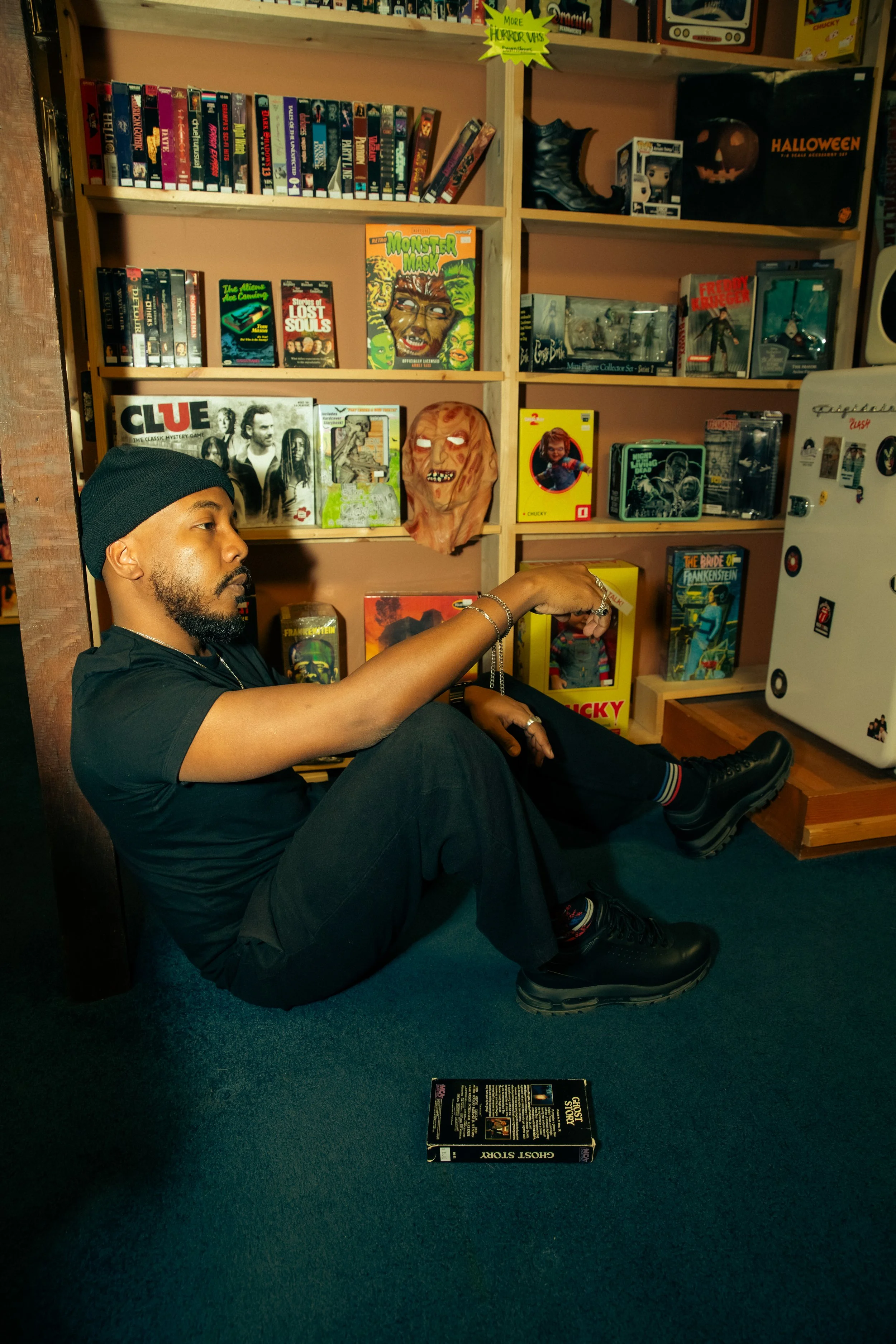 Cory standing by an open car trunk at night wearing a black beanie and jacket