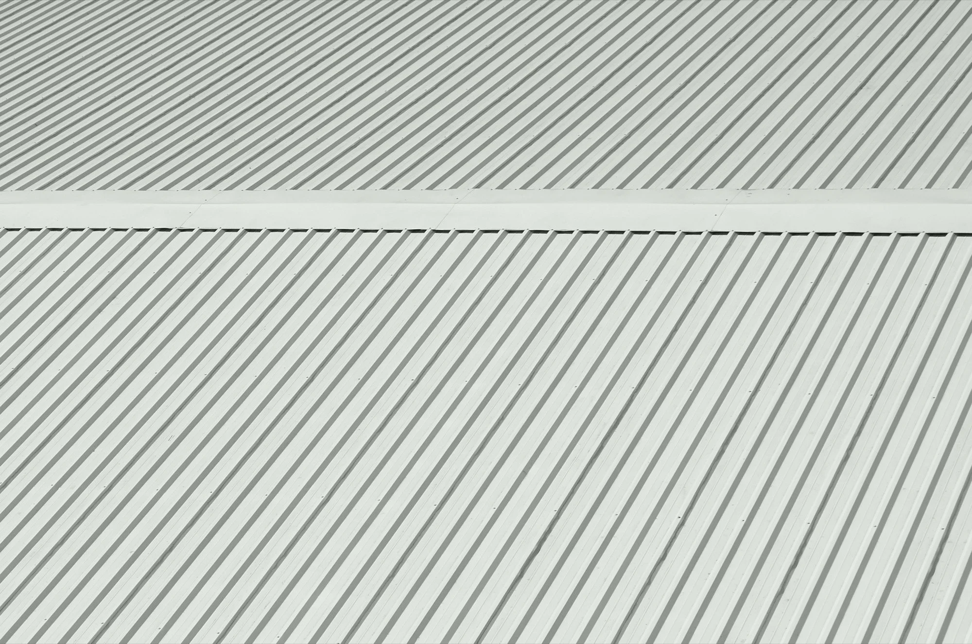 Close-up of a long-run steel new roof that has been cleaned by Hawksbill products.