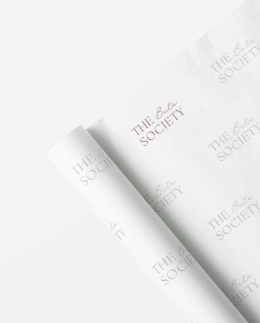 Close-up of a folded page with the text 'THE BIA SOCIETY' printed repeatedly on white paper.