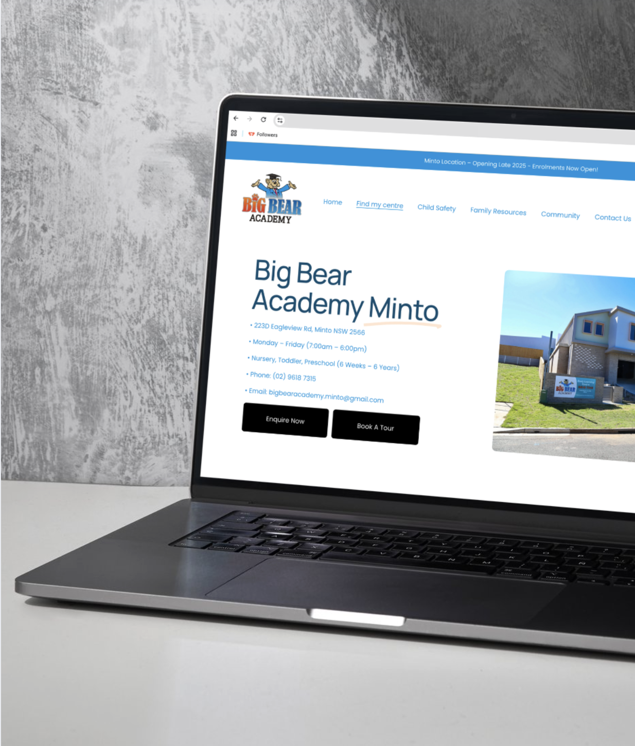 Laptop computer displaying the website for Big Bear Academy Minto with contact information, location, and options to enquire or book a tour.