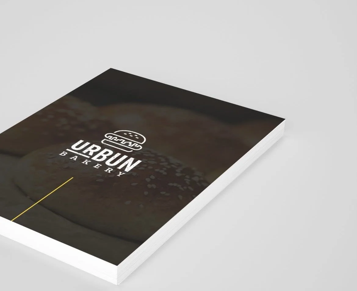 Brochure or menu for Urbun Bakery featuring a close-up of a baked item with a bubbly crust.