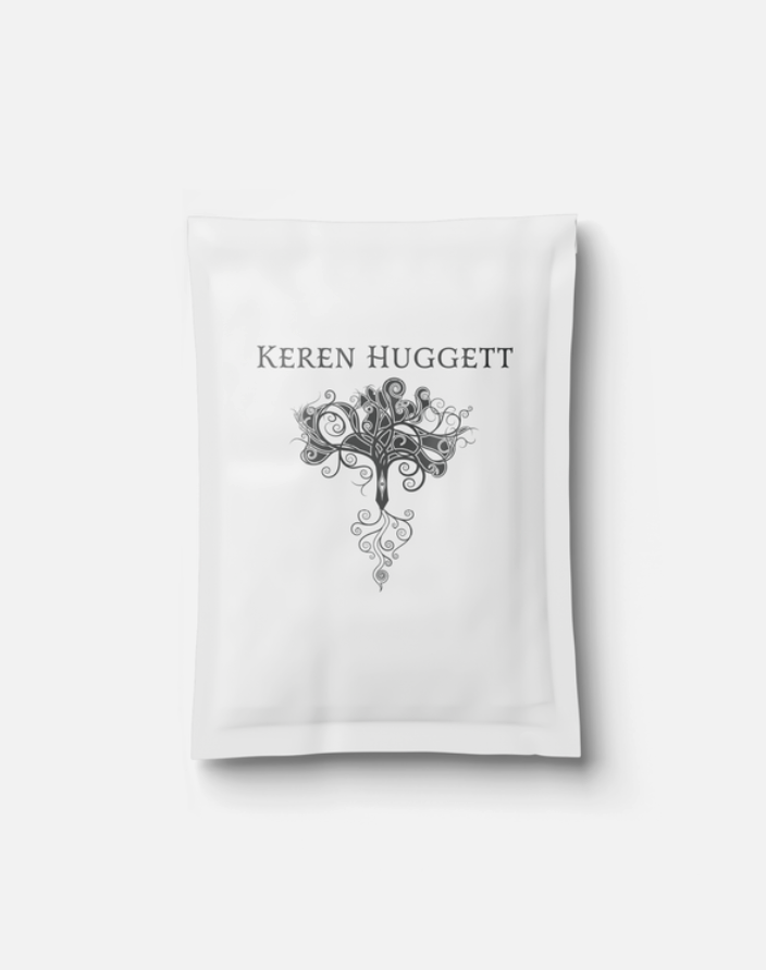 White package with the name Keren Huggett and a decorative swirling tree design