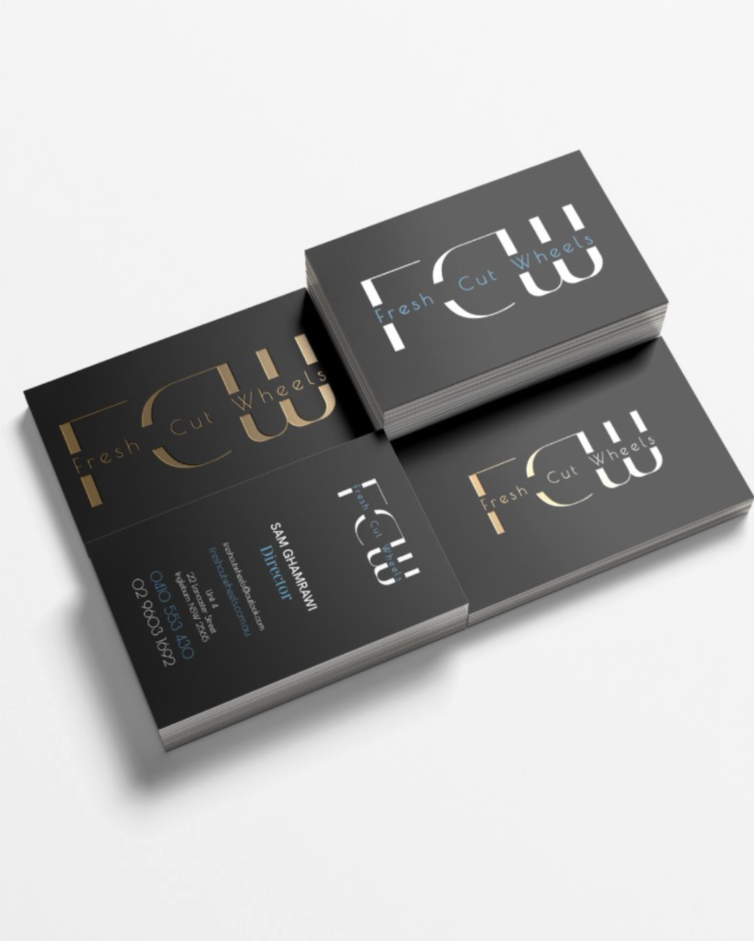 Business cards for Fresh Cut Wheels, a tire shop, with black background, gold and white text, and contact information.