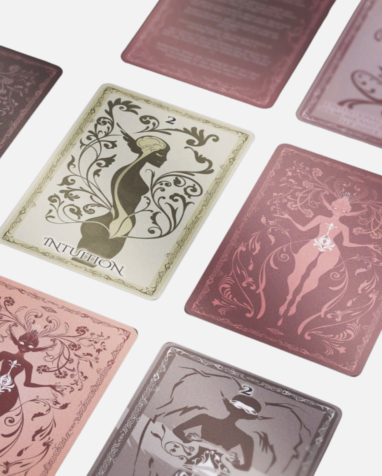 Collection of tarot cards laid out, including a card with a woman and floral patterns labeled "Intuition" and other cards with fantasy-themed illustrations.