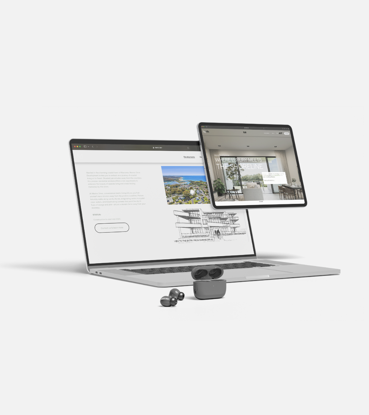 An open laptop displaying web pages, with a tablet and wireless earbuds placed around it on a plain white background.