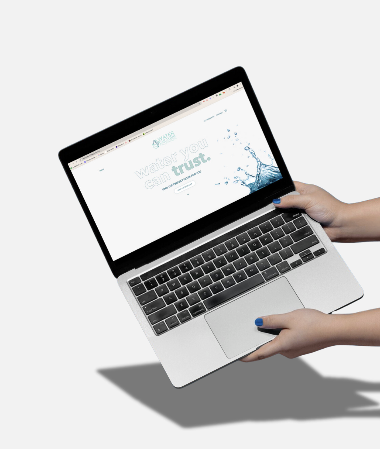 Person holding a laptop displaying a water filter website with the text 'Water you trust' and a splash of water image.