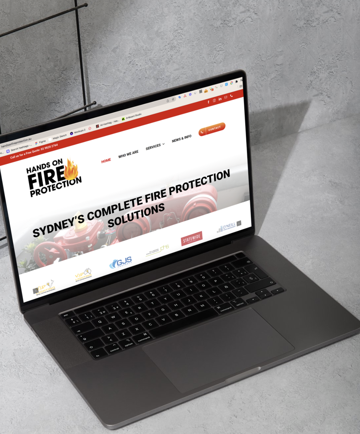 Laptop on a gray surface displaying a website for fire protection solutions in Sydney.
