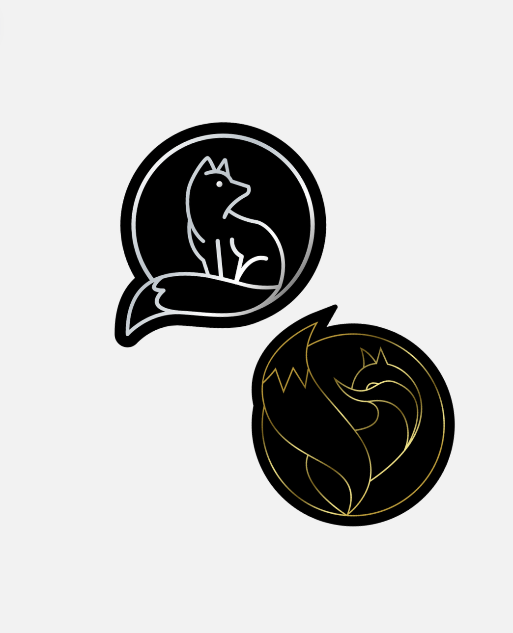 Two circular logos featuring stylized fox illustrations, one in black and white and the other in black and gold, on a light gray background.