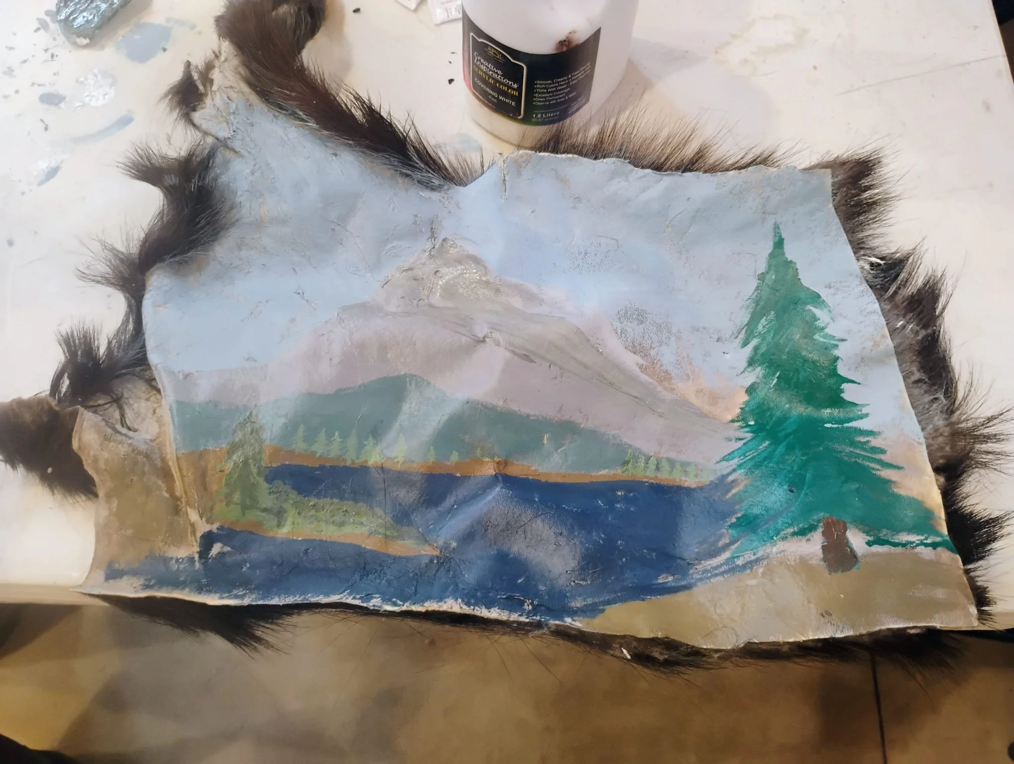 (Acrylic on ashed goat hide) by a student of the Ecology Learning Center