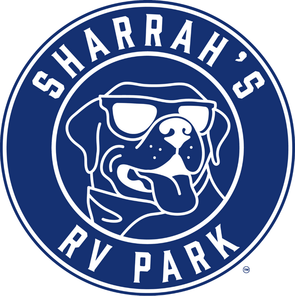 A circular logo featuring a dog wearing sunglasses and a bandana, with the text "Sharrah's RV Park" around the top and bottom of the logo.