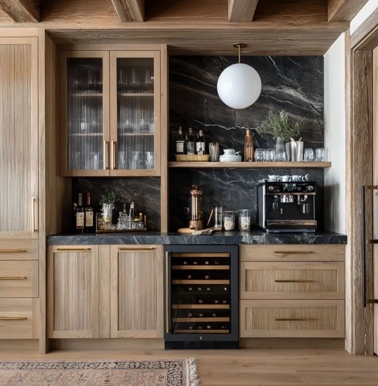 ✨ Where daily moments meet thoughtful design.

This coffee and bar nook blends warm wood textures, fluted cabinetry, and dramatic stone to create a space that feels both elevated and inviting. The perfect spot for a morning espresso or an evening pou