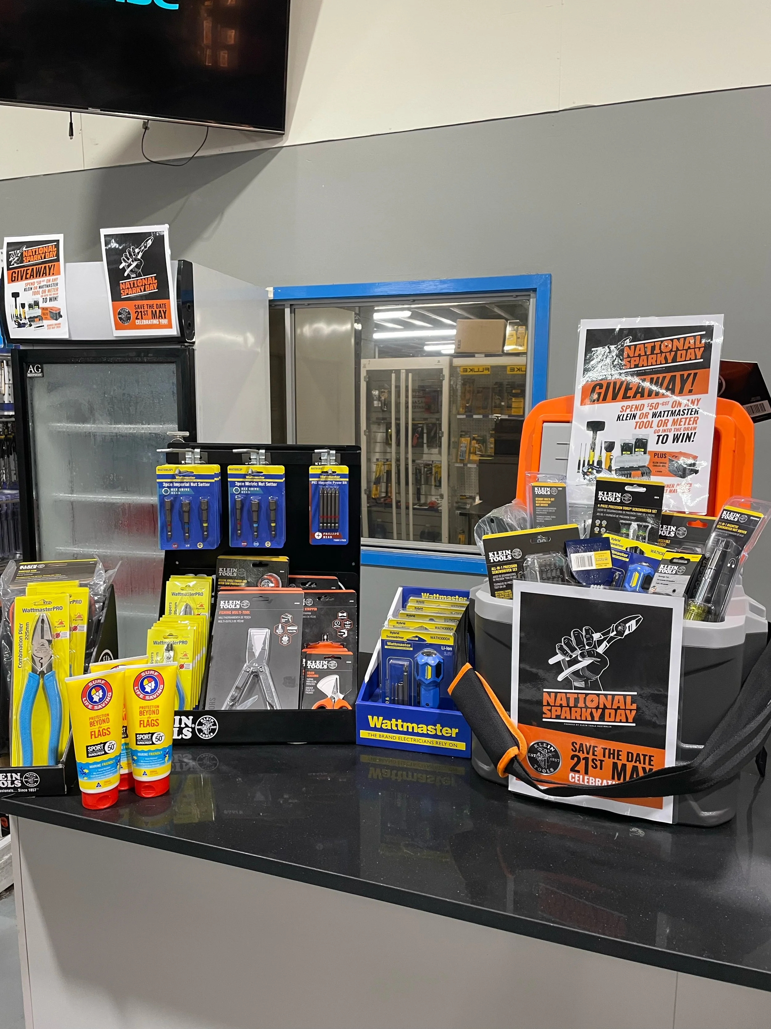 Display of various tools and promotional signs for a sales event at a hardware or tool store.