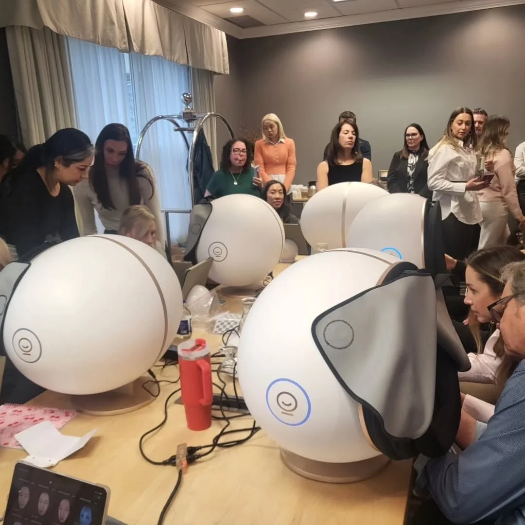 A group of people testing the EveLab Muse skin and facial analysis system