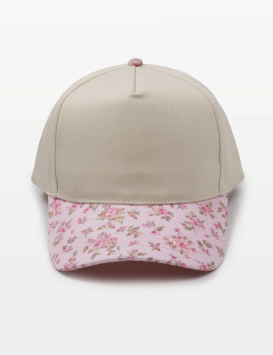 Cap with a beige crown and pink floral patterned brim.