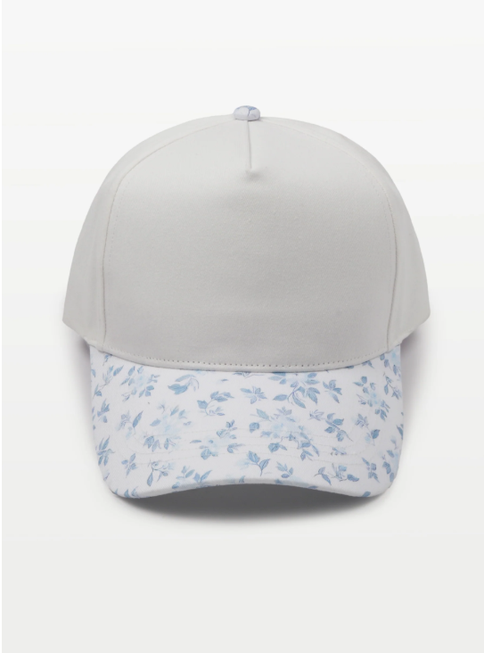White baseball cap with a light blue floral patterned brim and panel.