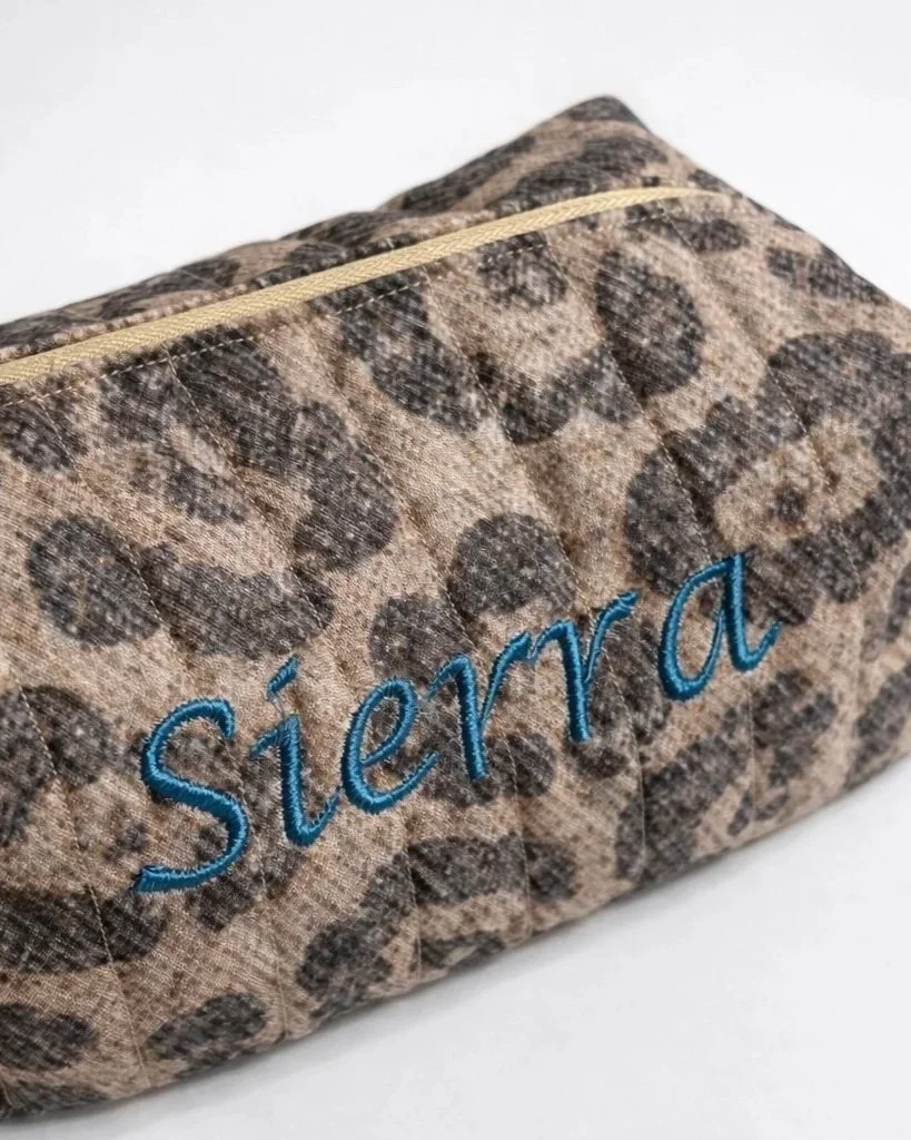 Quilted teal embroidered makeup bag with side handle from Sage Stitch Studio