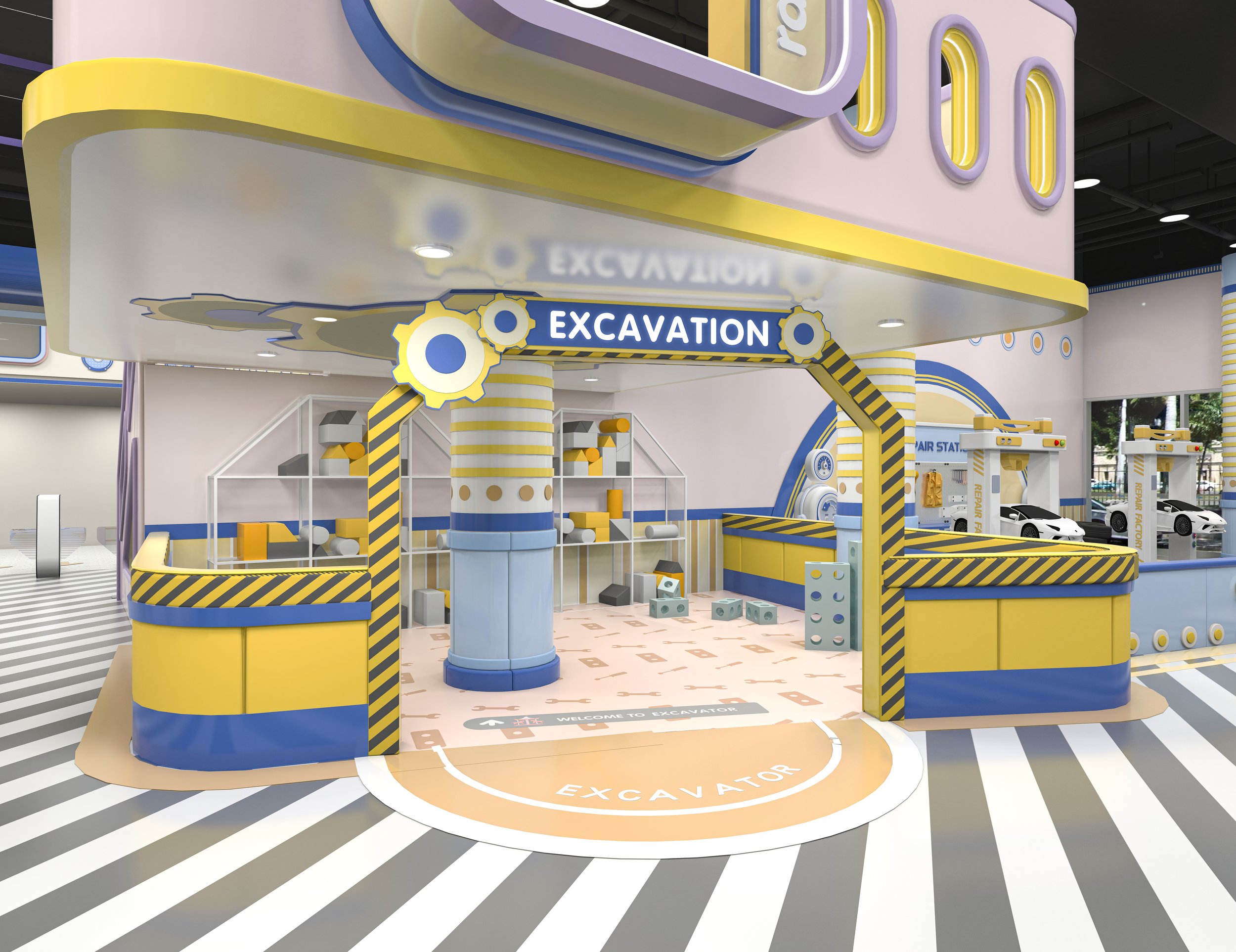 An indoor play area themed like a construction site with yellow, blue, and gray colors. It includes a sign that says 'Excavation' above the entrance, with various blocks and construction equipment inside, and a floor marking that says 'Excavator.' There are additional construction-themed structures and cars in the background.