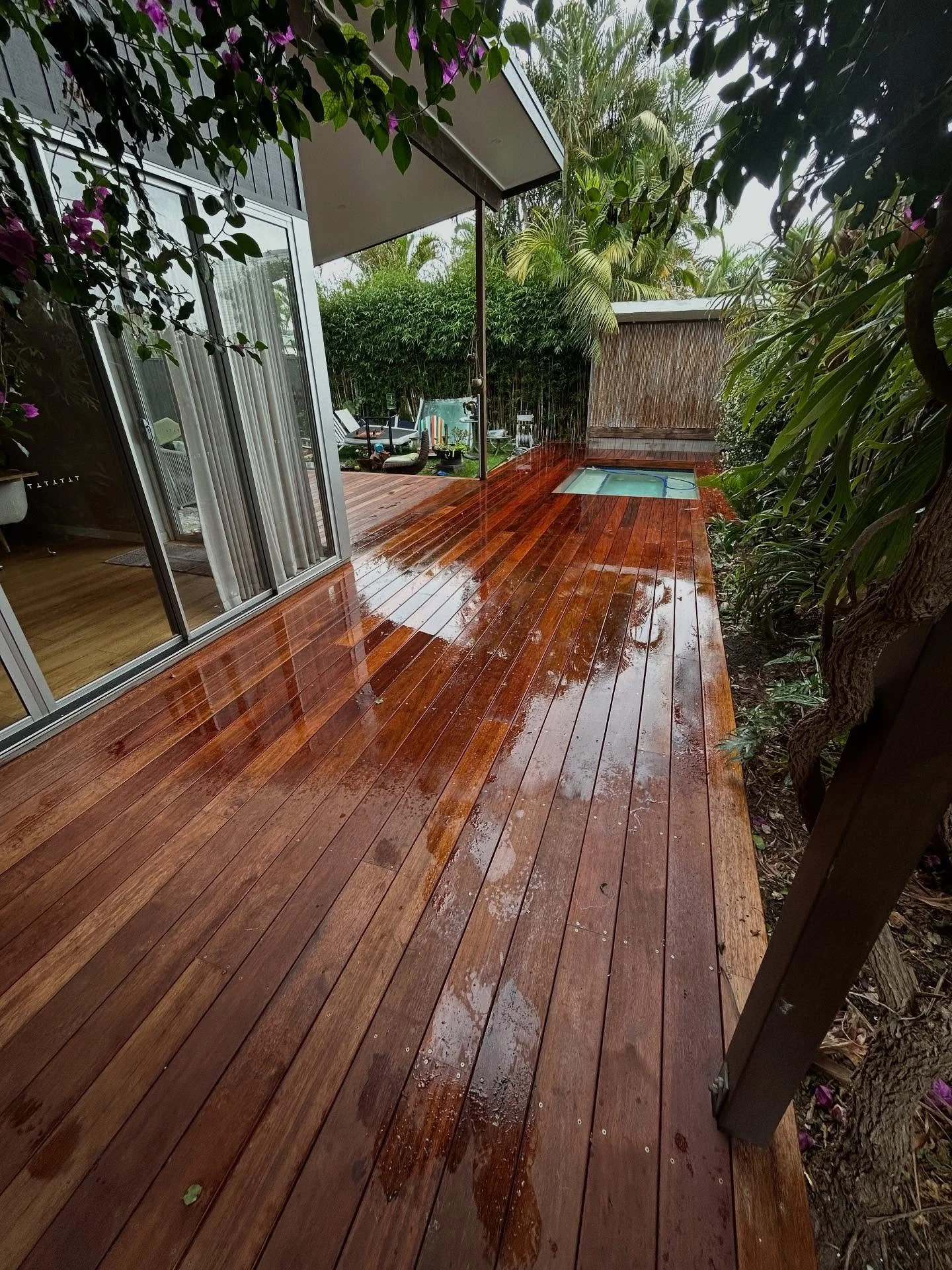 Miami deck renovation. We addressed existing issues, removing the step down to the pool area and reconfiguring the deck for seamless board alignment. For decking inquiries, contact us for a hassle-free quote on all your decking and patio roofing need
