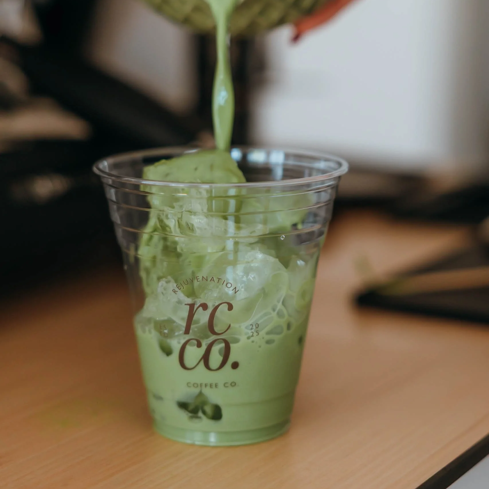 Barista pouring specialty matcha drink at Rejuvenation Coffee Co. event in Phoenix