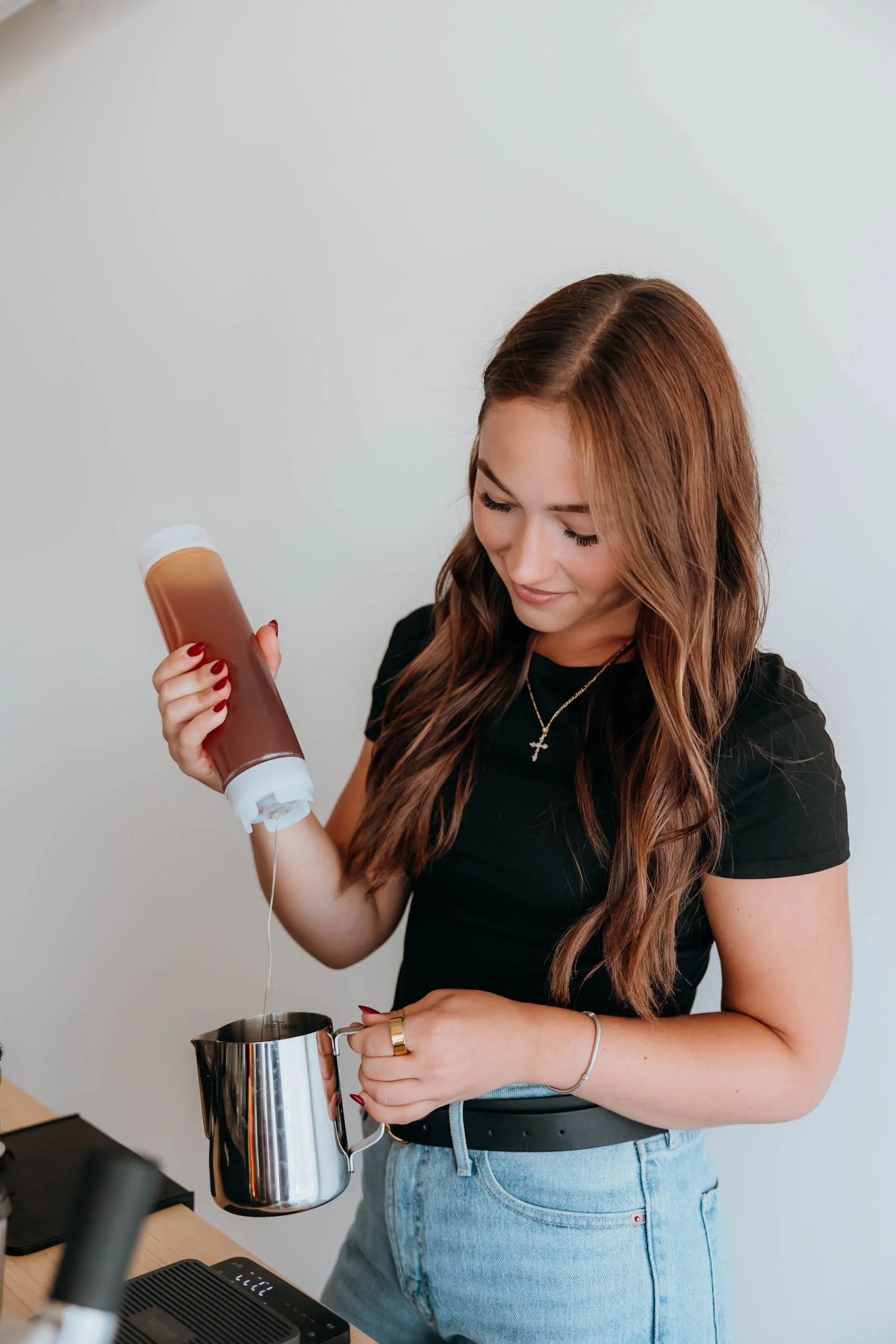 Professional barista preparing a specialty coffee drink at the Rejuvenation Coffee Co. mobile espresso bar.