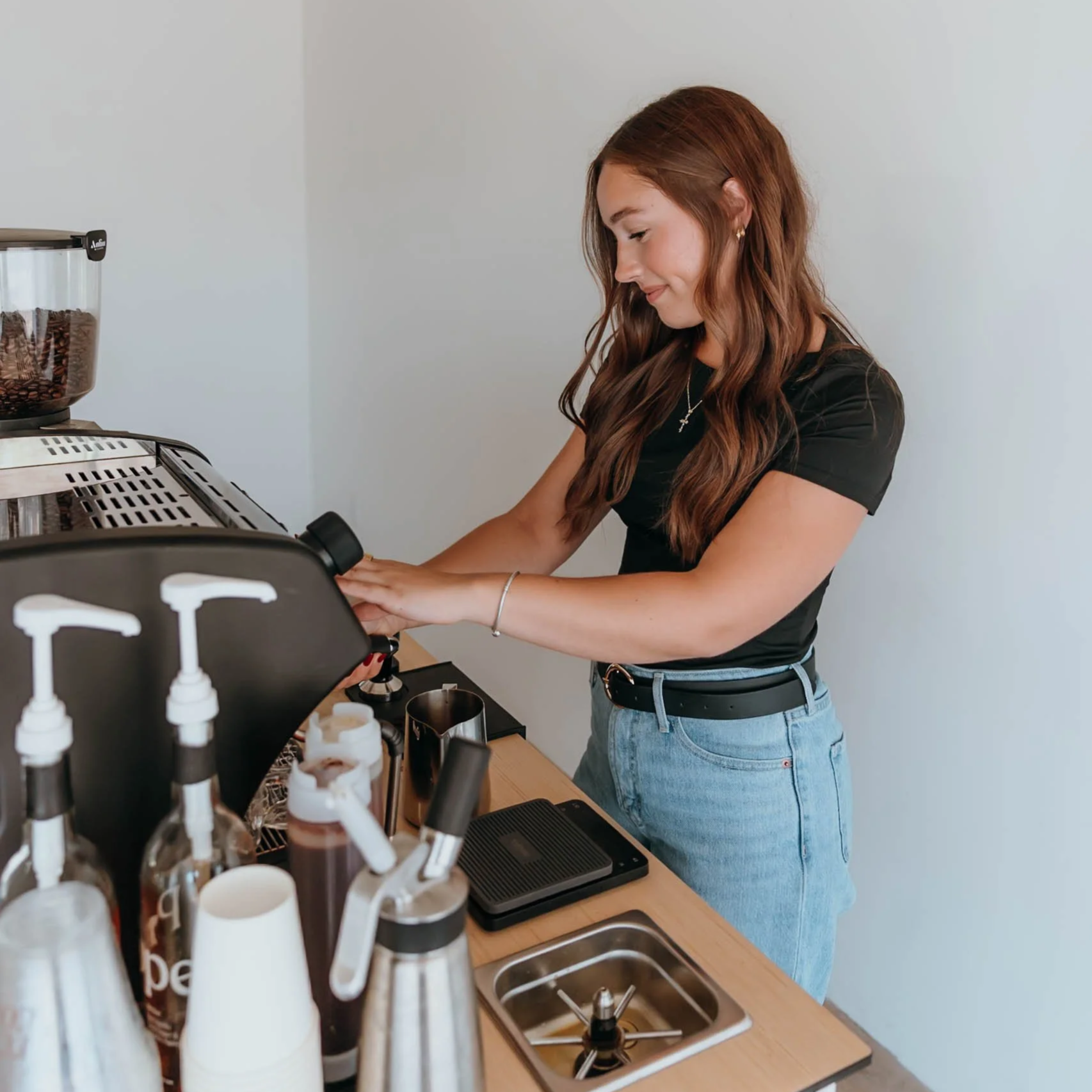 A professional coffee cart owner prepares drinks for customers at a Phoenix event.