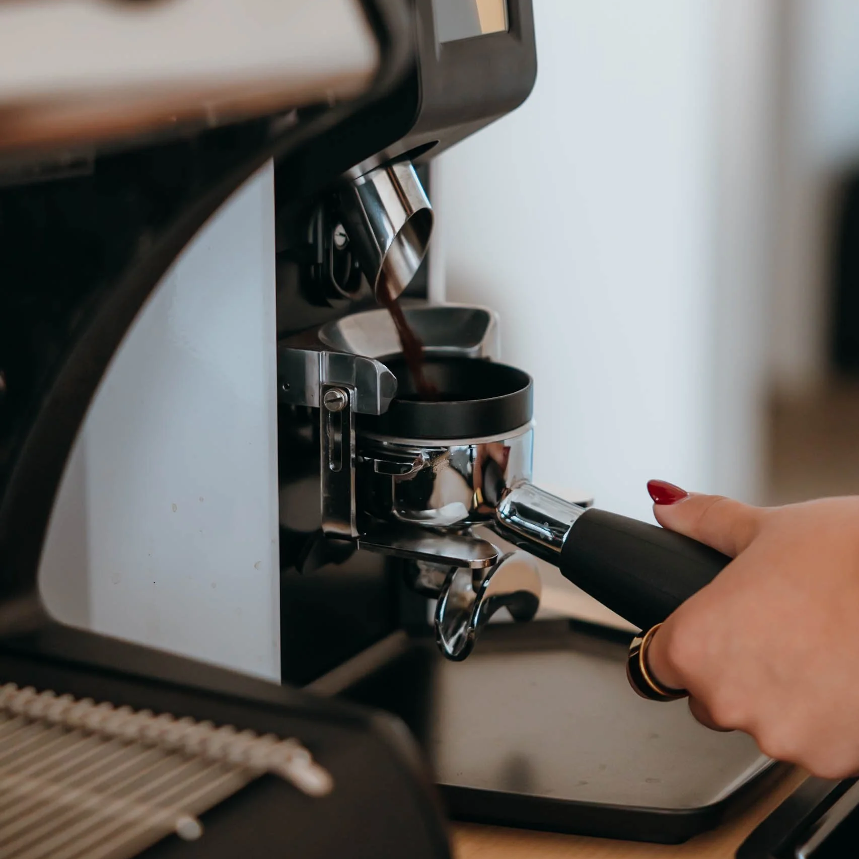 Rejuvenation Coffee Co. barista pulling fresh espresso grind with portafilter at Phoenix AZ coffee catering event.
