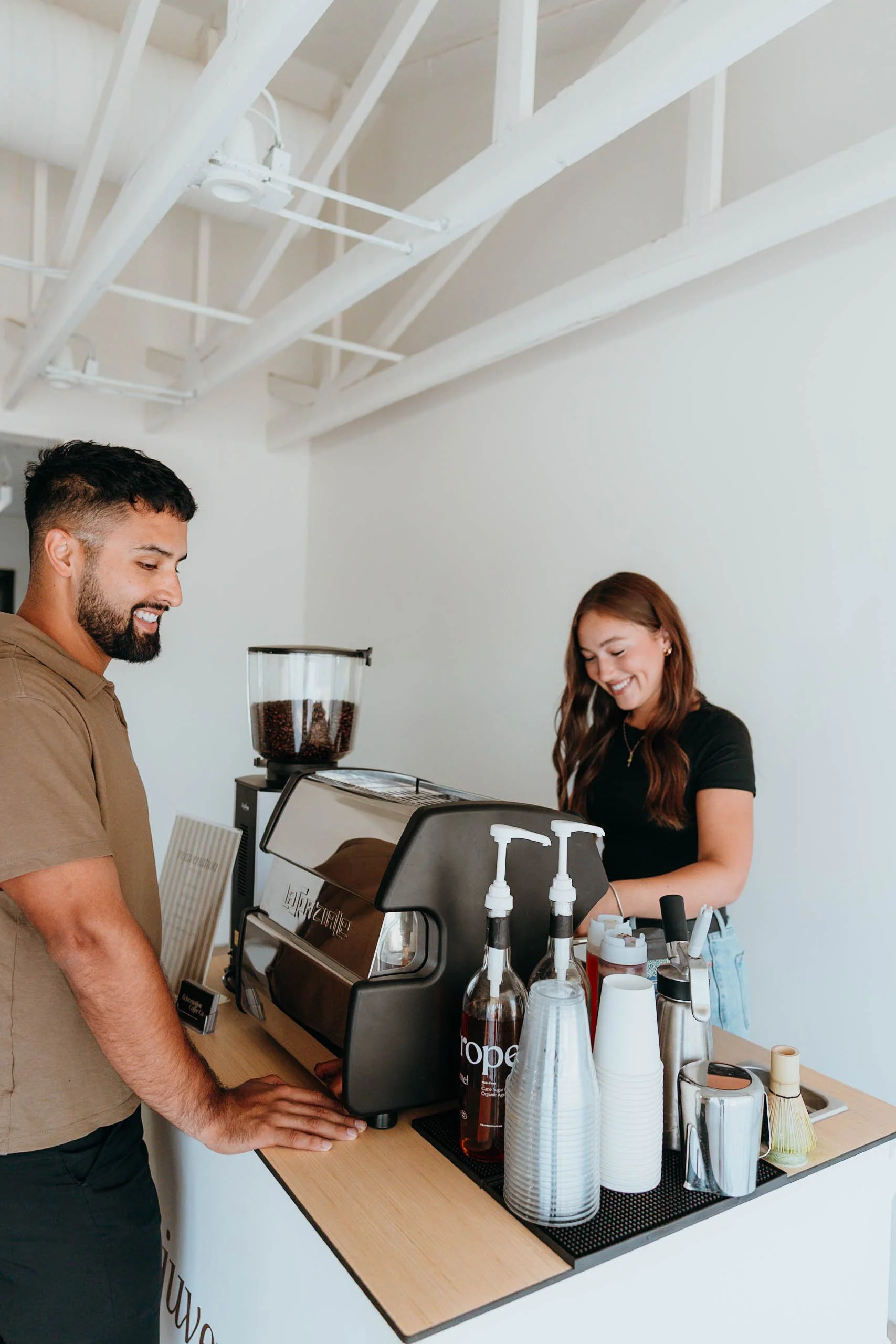 Professional barista preparing a specialty coffee for a guest at the Rejuvenation Coffee Co. mobile espresso bar.