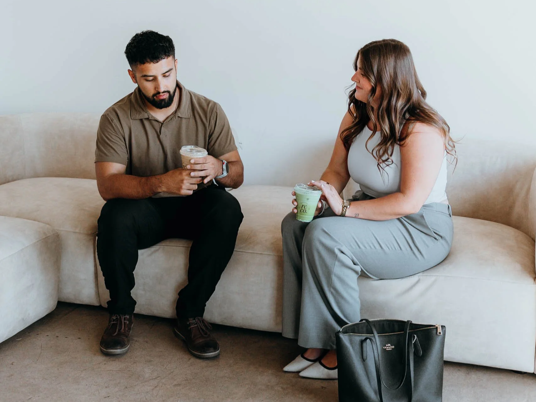 Two working professionals enjoying coffee from Rejuvenation Coffee Co, a mobile coffee cart in Phoenix, one man and one woman. 