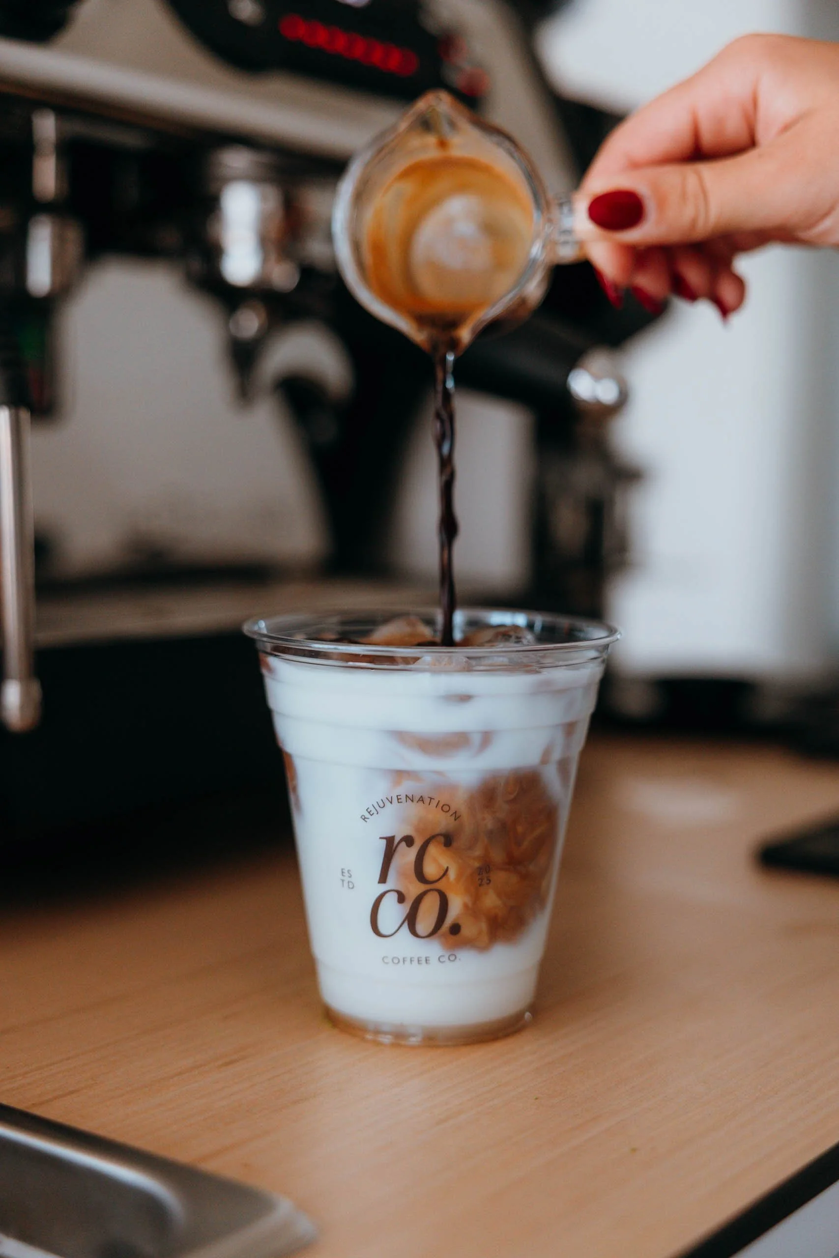 Rejuvenation Coffee Co. barista pouring a freshly prepared specialty coffee into a cup at a corporate event.