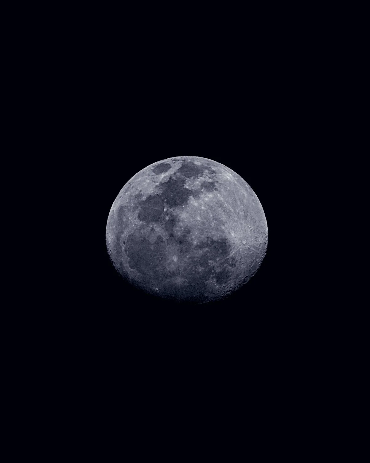 A detailed full moon against a black night sky.