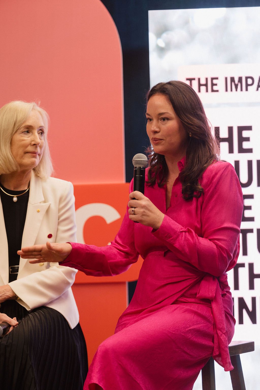 Kelly McJannett and Belinda Hutchinson speaking at the 2025 Impact Stage presented by Charitabl.