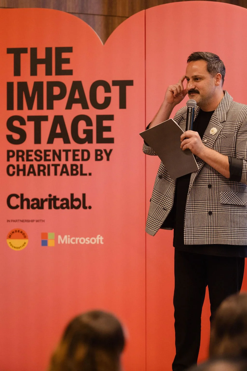 Ben Vasiliou speaking at the Impact Stage presented by Charitabl. in 2025