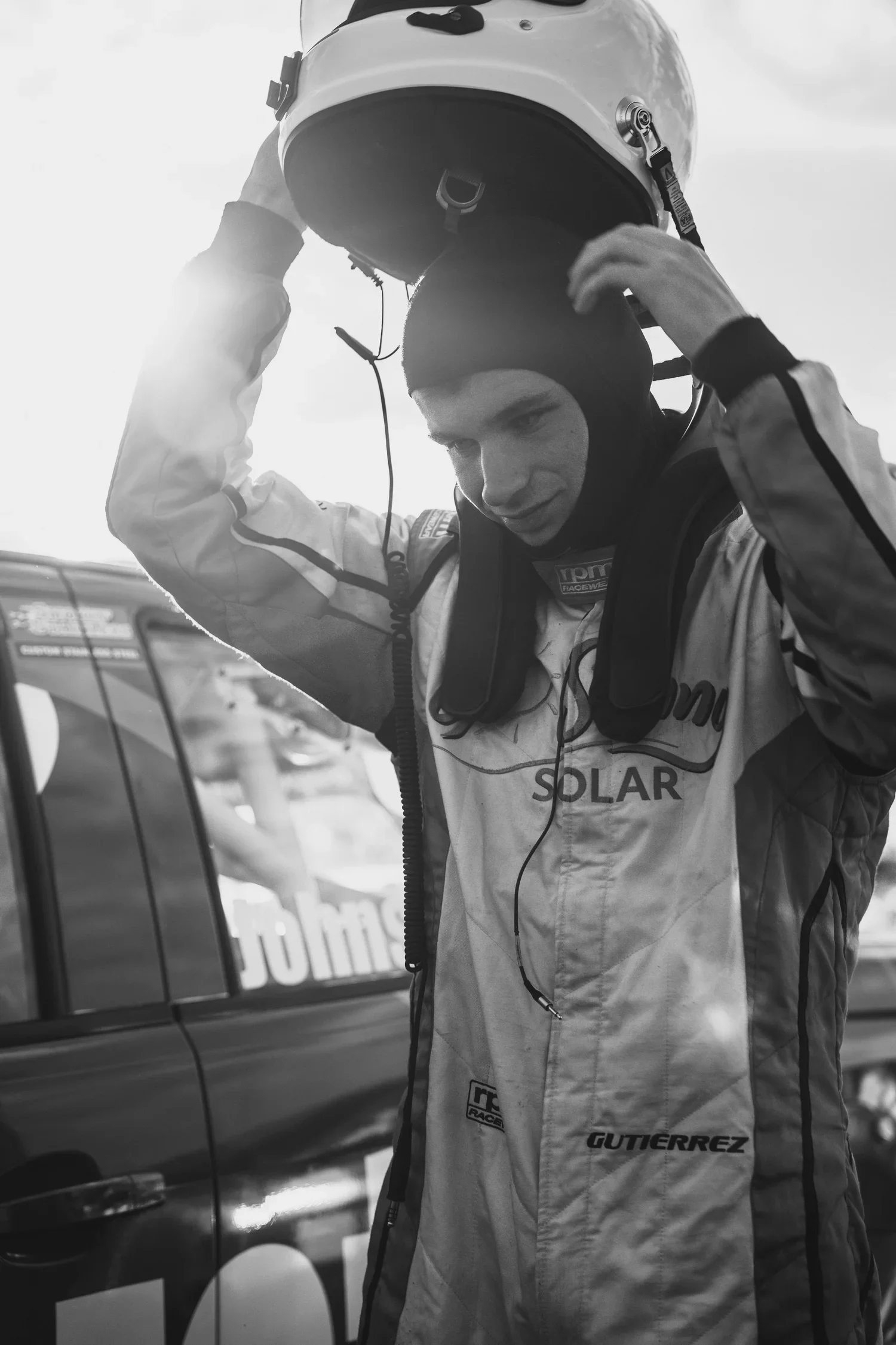 V8 SuperUte Series driver, Rossi Johnson putting on his race helmet.